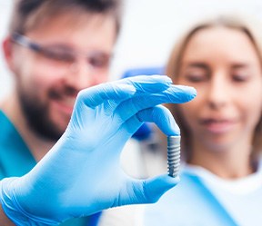 A blurred dentist getting ready to perform a dental implant surgery