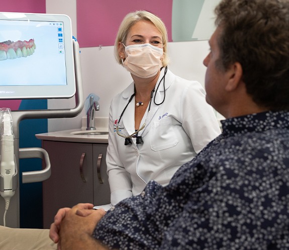 Dentist talking to dental patient