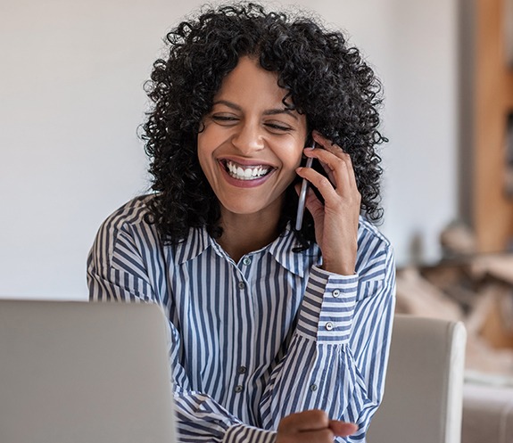 Woman calling to schedule her biannual dental office visit