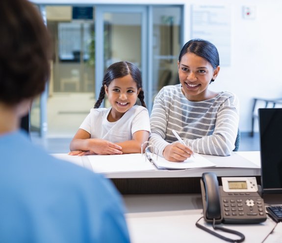 Mother and child discussing the cost of treating dental emergencies