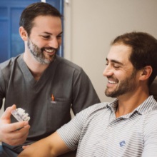 Dentist and dental patient reviewing tooth replacement options