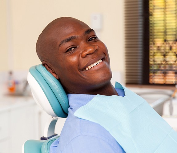 Man smiling after inlay and onlay treatment