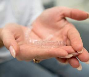 Patient holding clear aligners
