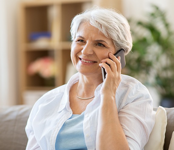 Woman calling to schedule a smile makeover consultation