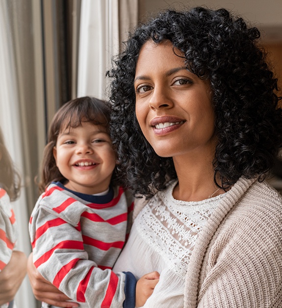 Mother and child smiling together after children's dentistry visit