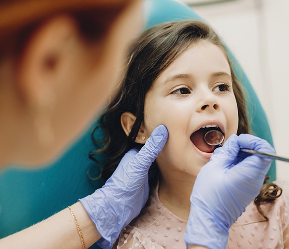 Dentist examining smile after tooth colored fillings