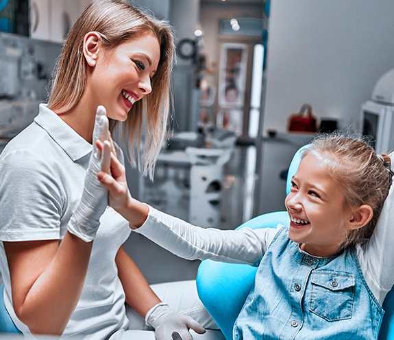 Child giving dentist a high five