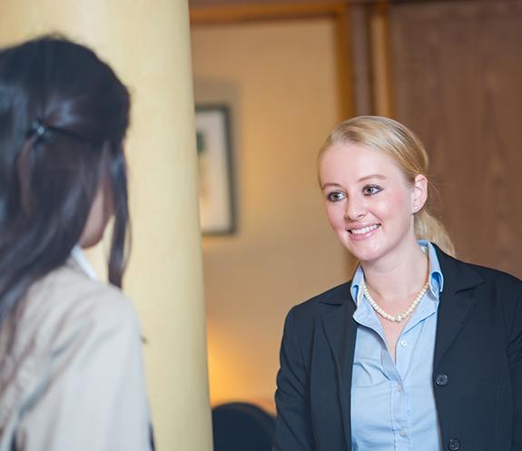 Dental team member smiling at dental patient