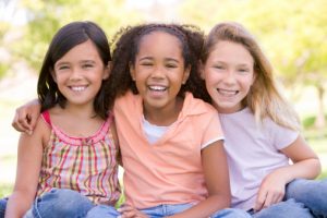 three young girls with beautiful smiles thanks to the washington kids dentist