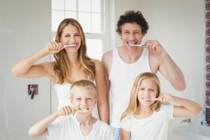 family brushing teeth