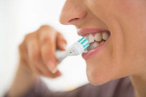 person brushing their teeth