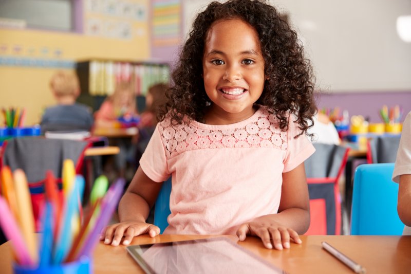 young girl smiling in classroom