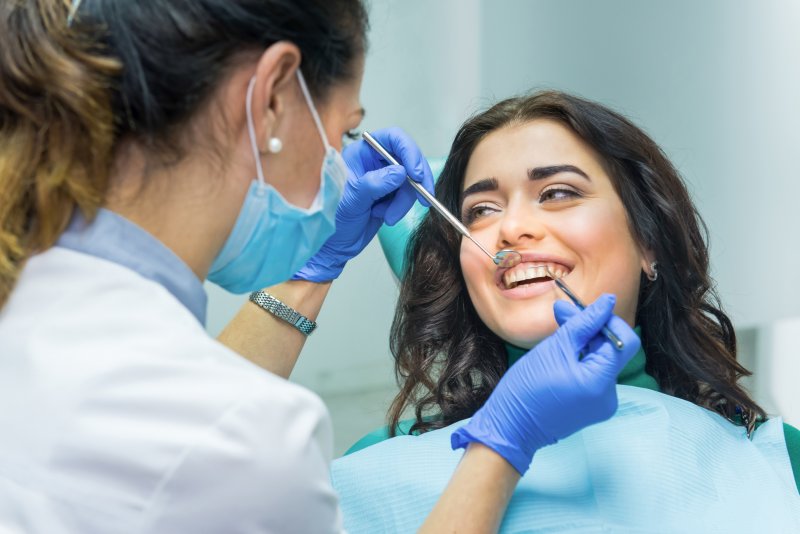 woman getting teeth cleaning in Washington DC