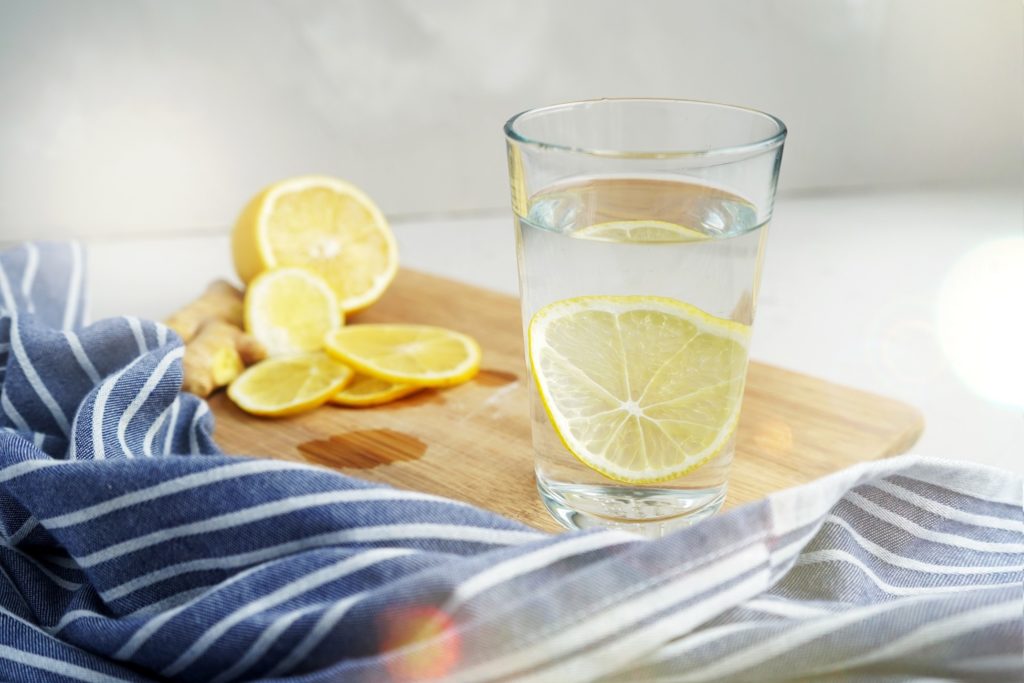 Lemons on cutting board with lemon water