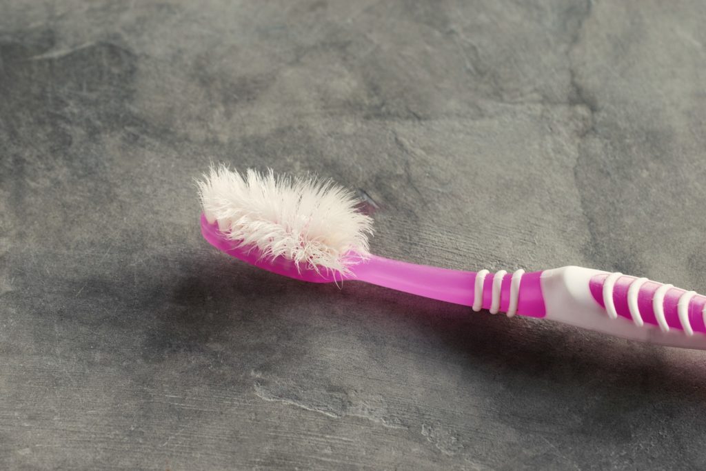Closeup of an old, frayed toothbrush