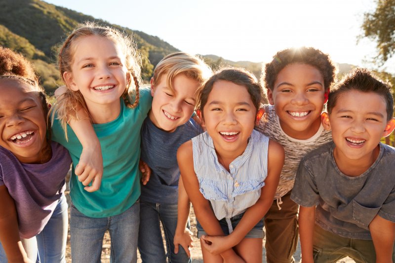 Kids with good oral health playing and smiling