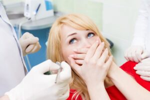 person looking scared at dentist
