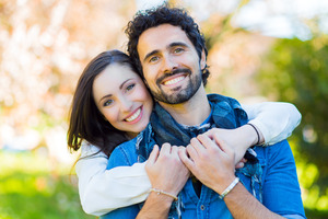 Smiling couple holding each other